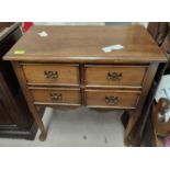 A mahogany reproduction four drawer lowboy with club legs and a shaped rectangular reproduction