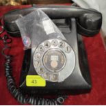 An early 20th century Rotary dial black Bakelite telephone; An enamel egg shaped pendant blue ground