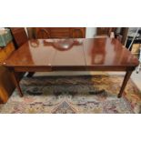 A late 19th/early 20th century rounded rectangular extended dining table, two spare leaves on square