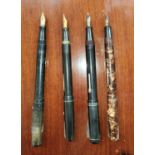 Four vintage fountain pens, Swan Self Filler, a Waterman's, and two other similar