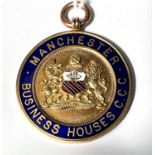 A 9 carat hallmarked gold medallion with enamelling, 'Manchester Business Houses CCC', inscribed,