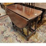 A 1930's oval oak drop leaf barley twist oak dining table.