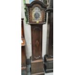 A 20th century oak cased grandmother clock with brass dialled face with Roman numerals, barley twist