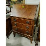 A reproduction mahogany bureau with fall front and 3 drawers
