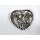 Georg Jensen:  a pierced heart shaped brooch with bird perched amongst foliage, numbered 239,