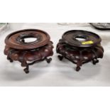 A matched pair of Chinese carved hard wood vase stands with naturalistic decoration, height diameter