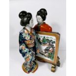 A Chinese ceramic famille verte group of two traditionally dressed women with screen between them,