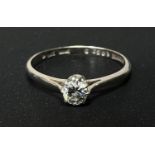 A white metal ring stamped '18ct', set solitaire diamond, stone diameter 3.5mm approx, size 'M', 1.