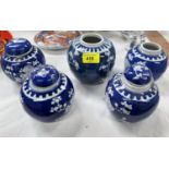 Five Chinese blue and white prunus blossom ginger jars, one larger with double circle mark to