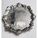 A Georgian hallmarked silver circular scalloped waiter with shell border and chased decoration,
