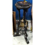 A Victorian ebonised torchiere with tripod stand circular top with metal fittings and carved detail,