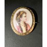 A miniature bust portrait on porcelain brooch of a young lady in 18th century dress in yellow