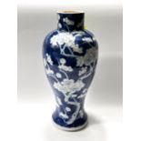 A 19th century Chinese blue and white inverted baluster vase decorated with prunus blossom on