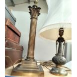 A brass Corinthian column table lamp; another similar bronzed lamp