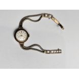 A lady's 9 carat hallmarked gold wristwatch on 9 carat strap, gross weight 13gm