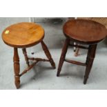 Two oak stools with circular tops, one with four legs one with three