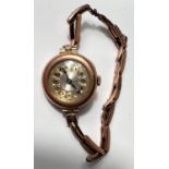 An Edwardian lady's 9 carat hallmarked gold wristwatch on yellow metal expanding bracelet,