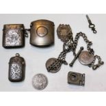Three hallmarked silver vesta cases; a watch chain with medallions; etc.