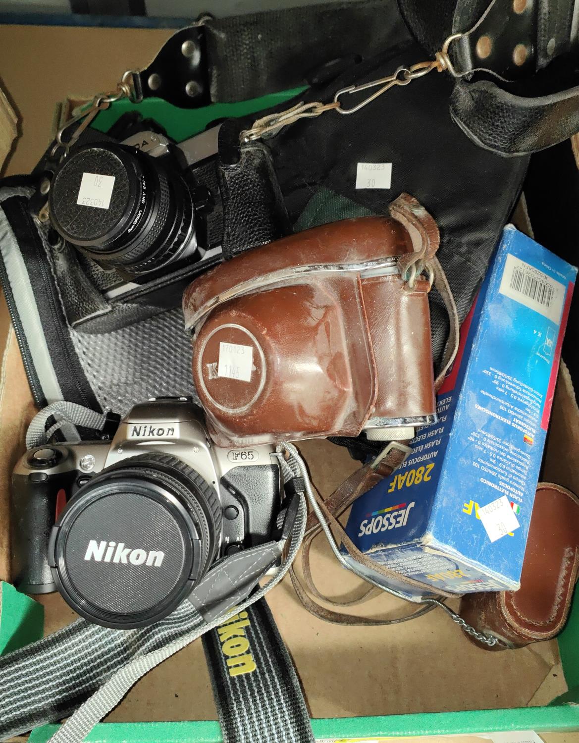 A Nikon F65 SLR camera; a similar Fujica camera; a Kodak camera; etc.