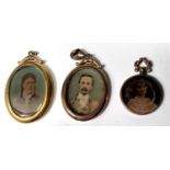 A yellow metal pendant photo locket, double sided, stamped '9ct'; a similar locket, marks unclear; a