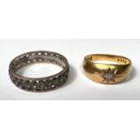 An 18 carat hallmarked gold gypsy ring set small diamond, size 'M', 2.2gm; a gem set eternity ring