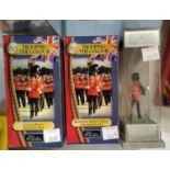 Three boxed Britain soldiers, two Trooping the colours Scots Guard and Grenadier guards and another