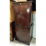 A reproduction figured mahogany drinks cabinet with double cupboard above and below