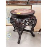 A Chinese carved and pierced wooden occasional table/ vase stand, with central marble piece floral
