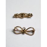 A bar brooch in the form of a bow, stamped '9'; a bar brooch in the form of 2 links, unmarked