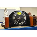 An Art Deco electric mantel clock; 2 resin figures and a cased pair of binoculars