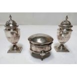 A pair of hallmarked silver classical pedestal salt and pepper pots on square stepped bases,