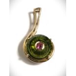 A 9 carat gold pendant formed from a round fern green quartz stone, the centre removed and set
