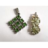 A 9 carat white gold openwork diamond shaped, set 9 green stones; a 9 carat gold pendant set