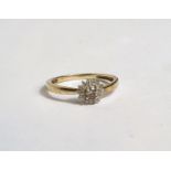 A lady's 9 carat gold dress ring set central champagne diamond, surrounded by small white diamonds