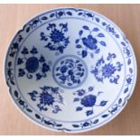 A Chinese blue and white bowl with lobbed rim, floral decoration to the interior a six character