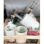 A selection of vintage stoneware storage jars and similar glass bottles