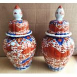 A pair of late 19th century Imari covered baluster vases with domed lids and ribbed bodies, ht. 37cm