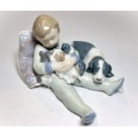 A Lladro figure of a child sitting on pillow with puppies, No. 1535