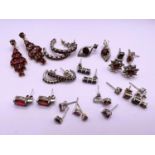 A selection of earrings set with red coloured stones