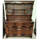 A large reproduction oak Welsh dresser with triple cupboards and drawers bellow with leaded glass