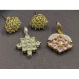 An 18ct gold pendant 'snowflake' pattern set with pale green stones; a pair of similar 9ct earrings;