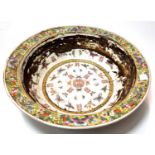 A large Chinese famille jaune basin bowl with butterfly and moth decoration, mark to base, 34cm dia