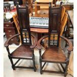 A pair of oak Arts and Crafts style 'Shakespeare Chairs' with thin panelled and pierced back,