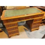 A good quality Adam Richwood reproduction pedestal desk with 9 drawers, green leather insert with