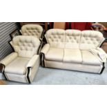 A modern cream button back three piece suite with three seater settee two armchairs one reclining
