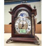 A bracket clock in reproduction mahogany case with brass dial, moon phase, the movement striking