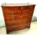 A Georgian figured mahogany bow front chest of 3 long and 2 short drawers with brass ring handles,