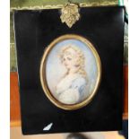A 19th century miniature portrait of a young woman with blonde hair and blue dress in ebonised