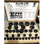 A wooden cased set of Robur Bakelite watch glass fitting dies 35 in total various sizes etc