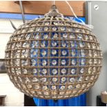 A globe shaped ceiling light fitting aged metal effect with glass pieces between
